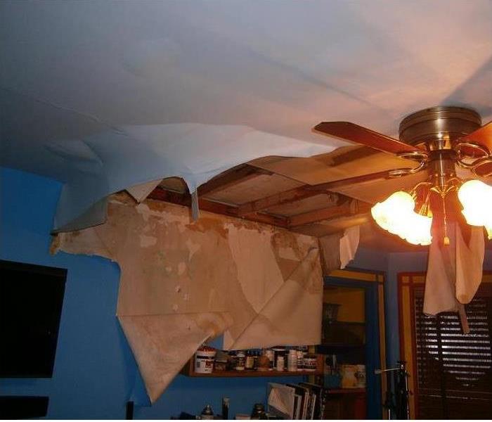 peeling walls and damaged ceiling, fan present