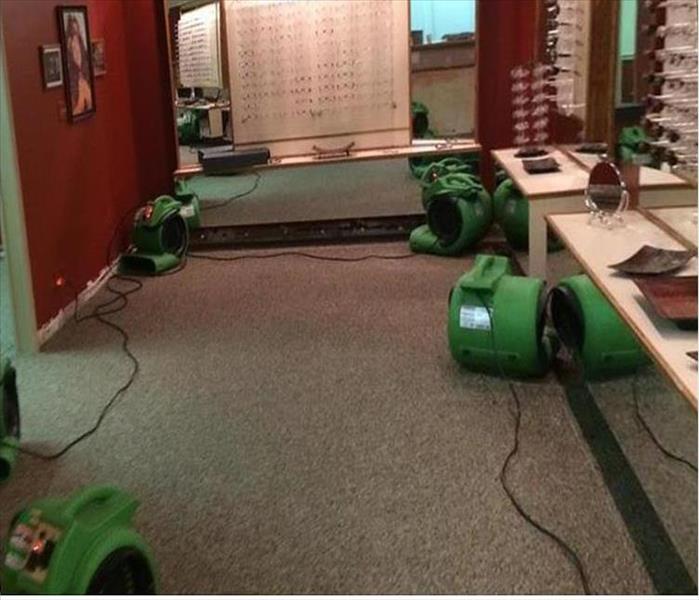air movers green in an eyeglass store drying wet carpet